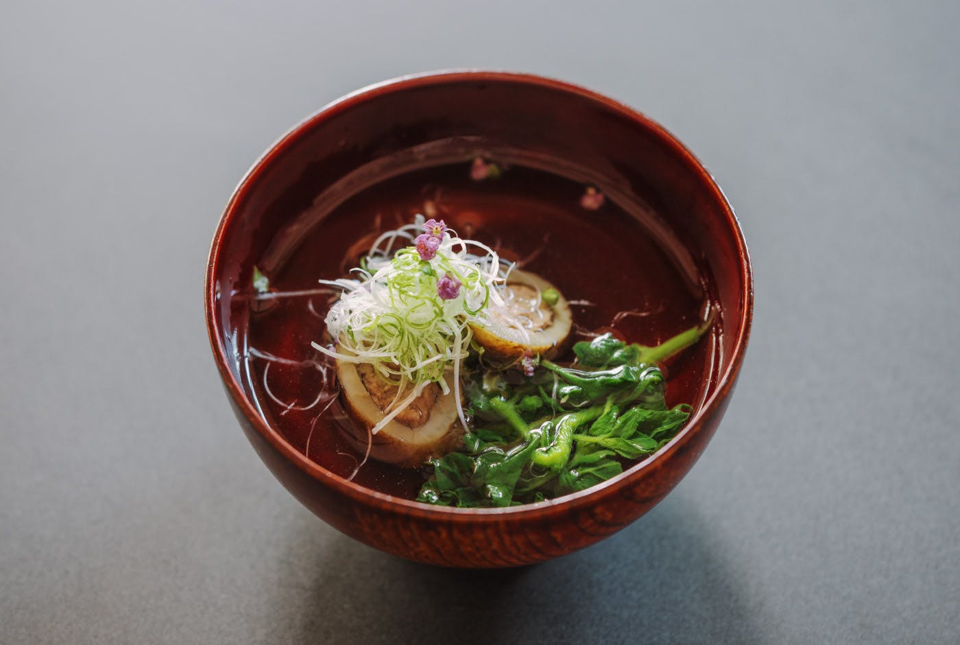 Stuffed burdock with minced duck in a clear soup